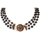 Three-row garnet altered necklace with an antique 14K. yellow gold closure.