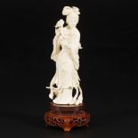 An ivory Guanyin on a wooden base, China, early 20th century.