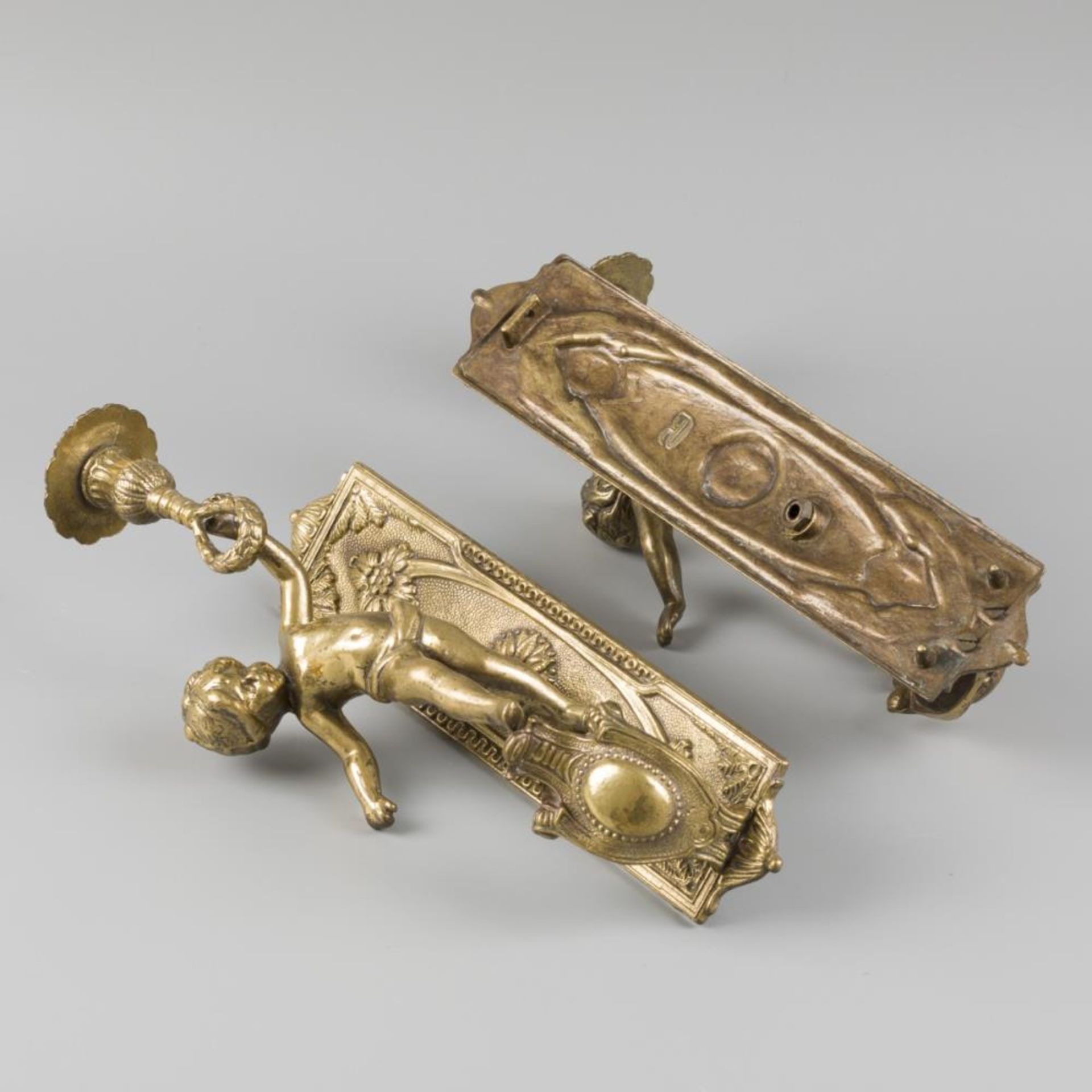 A lot comprising (2) candlestick holders, adorned with putto holding a candleholder, 20th century. - Image 2 of 2
