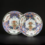 A set of (2) porcelain famille noir plates decorated with phoenixes in the rim and a vase in the cen