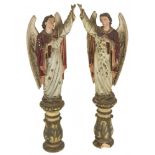 A pair of polychrome sculptures of angels.