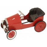 A red laquered pedal car.