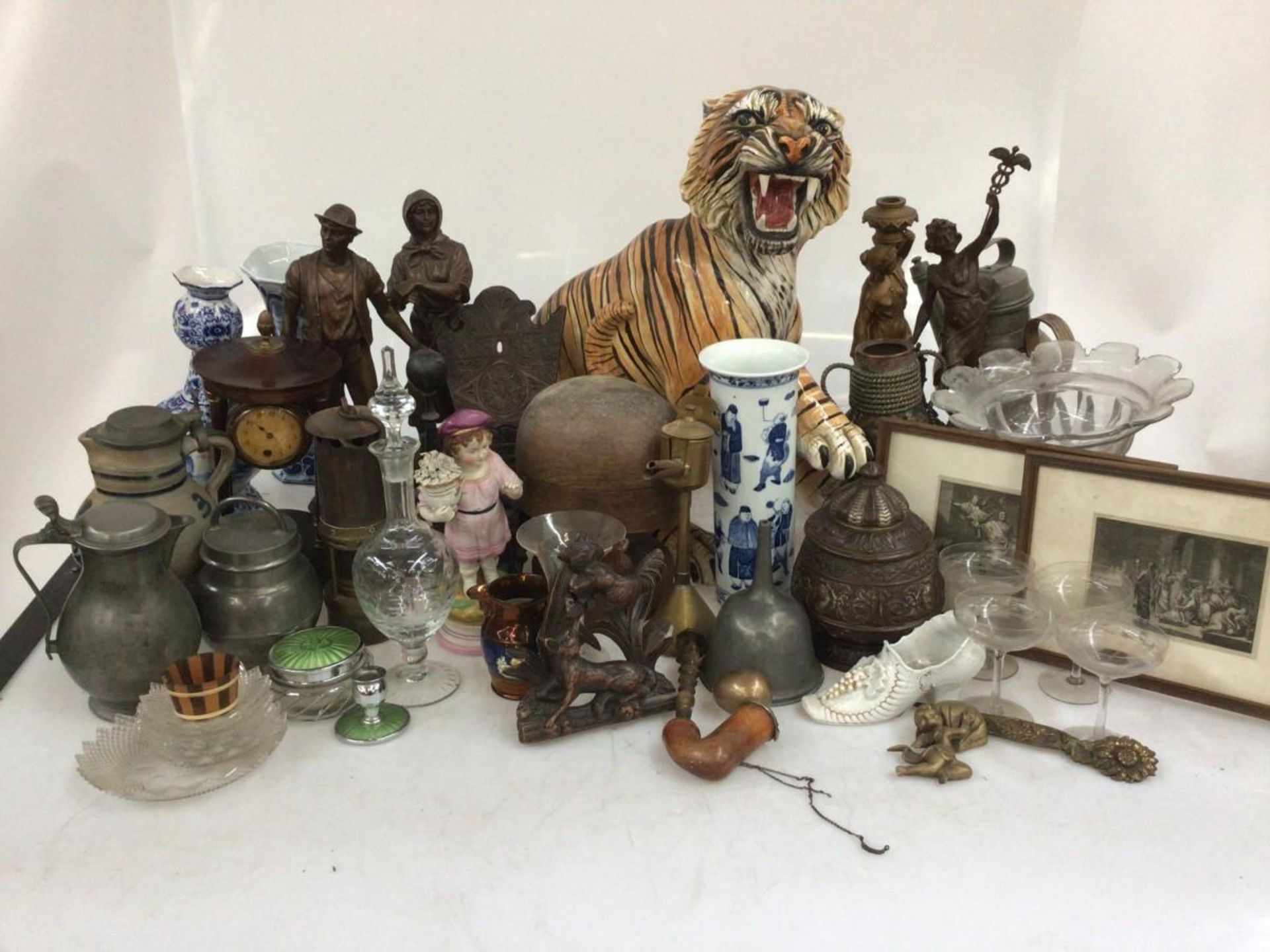 A large lot consisting of a glazed tiger (with damage), gourd vases, etchings, pewter and stonework.