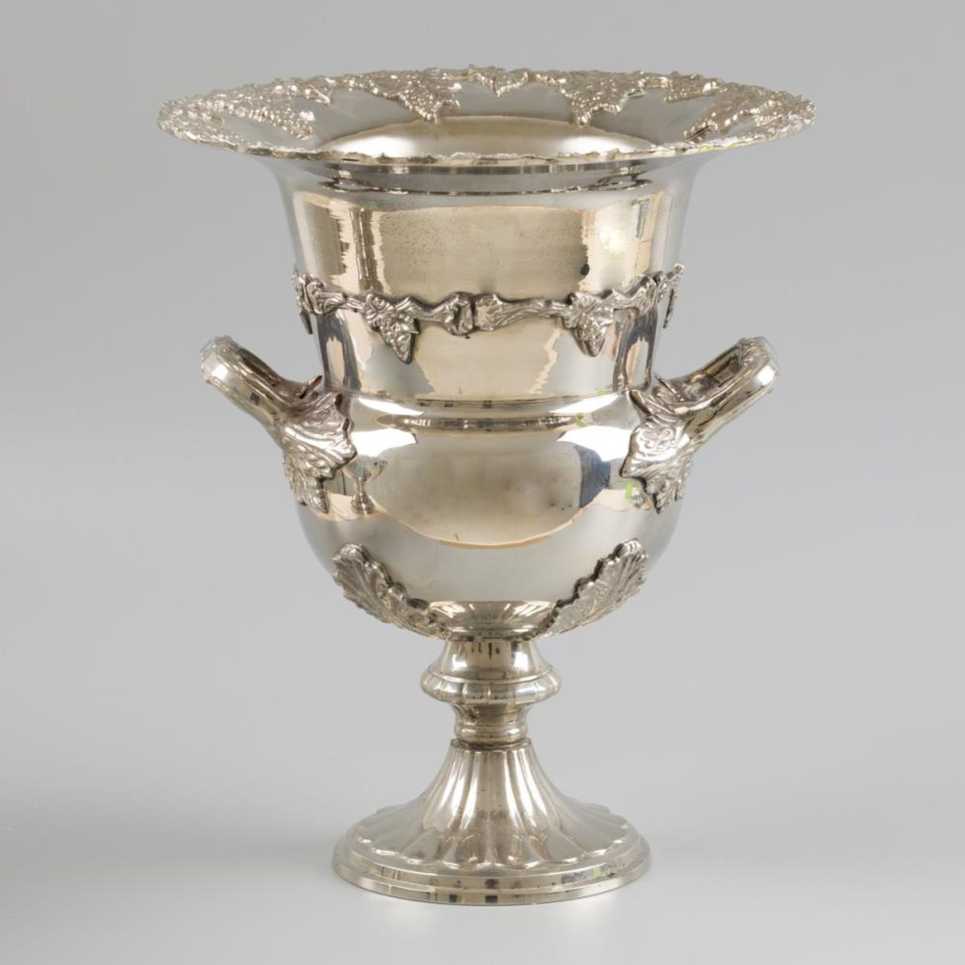A silver-plated champagne cooler with two handles and decorated with bunches of grapes. England, lat