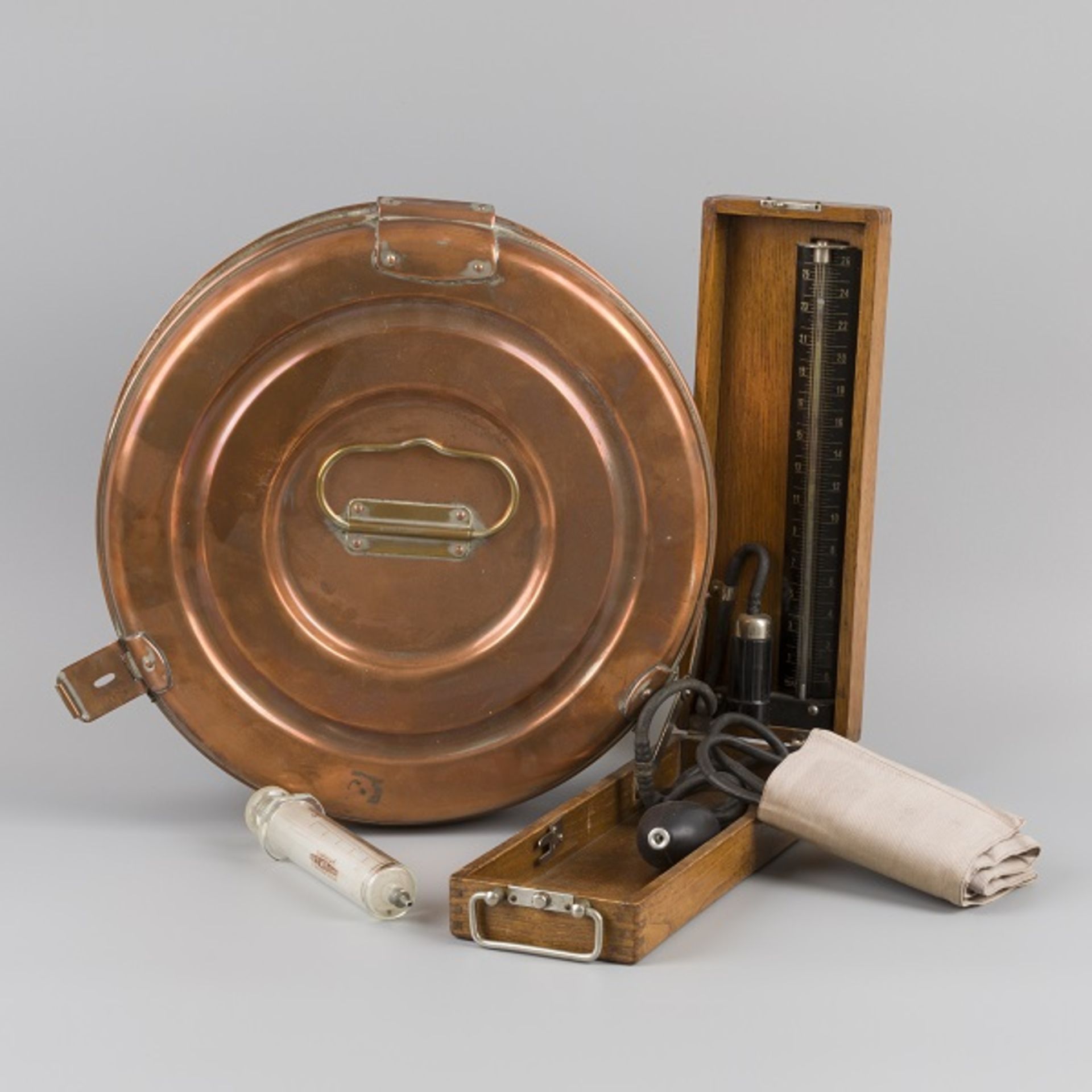 A round brass doctors instrument sterilisation box with glass spout and bloodpressure device, medica