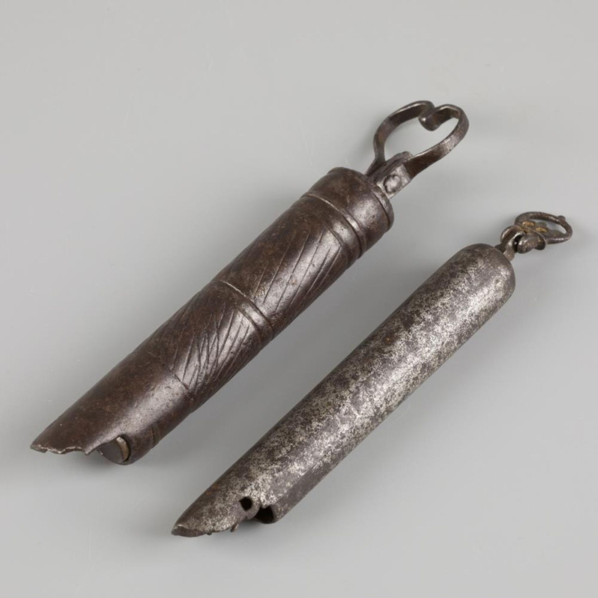 A lot comprising two iron cheese spatula, including measuring device, Dutch, 18th/ 19th century.