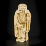 An ivory okimono depicting a sweeper/ happy old man, Japan, Meiji period, late 19th/ early 20th cent