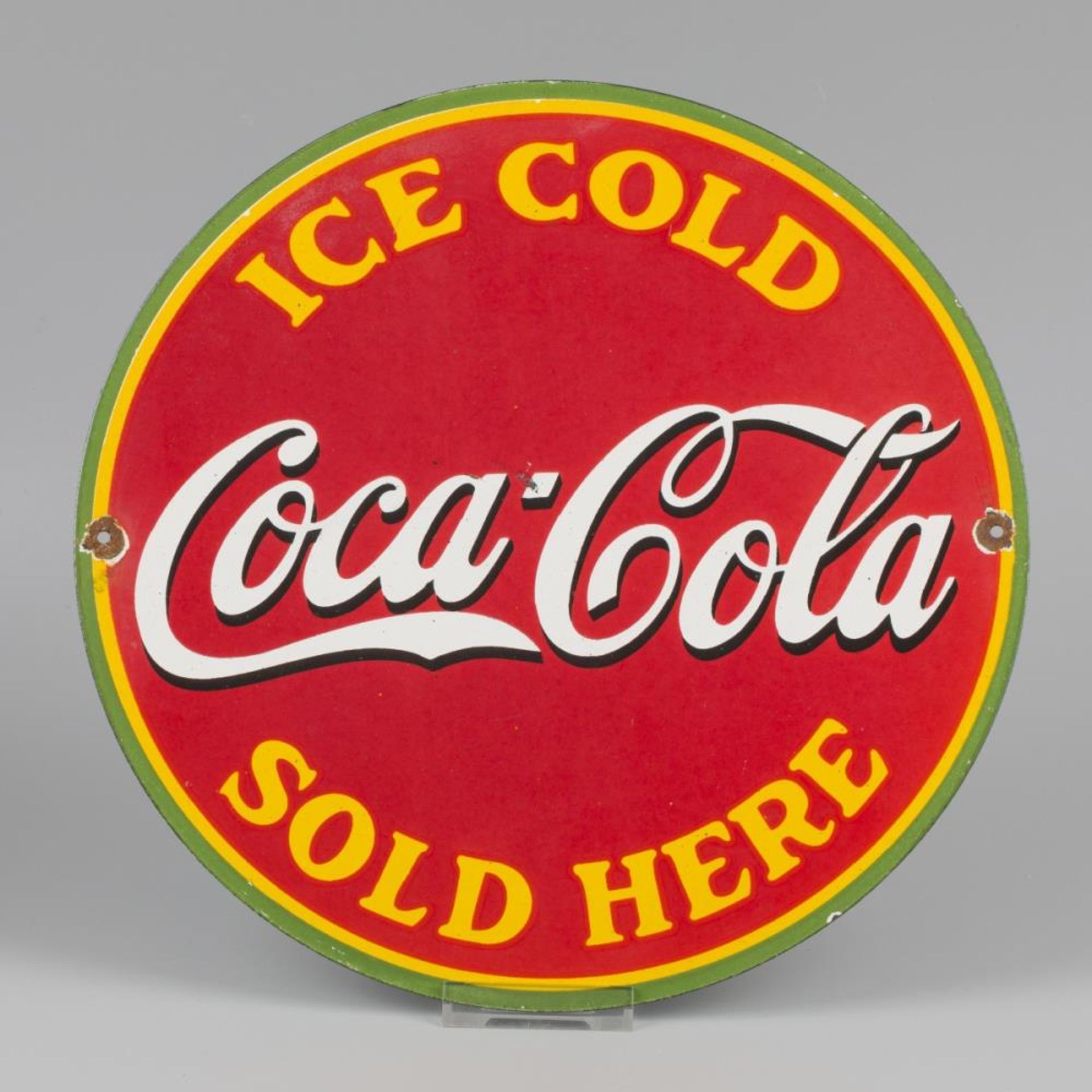 An enamel advertising board with a picture of Coca-Cola. Mid 20th century.