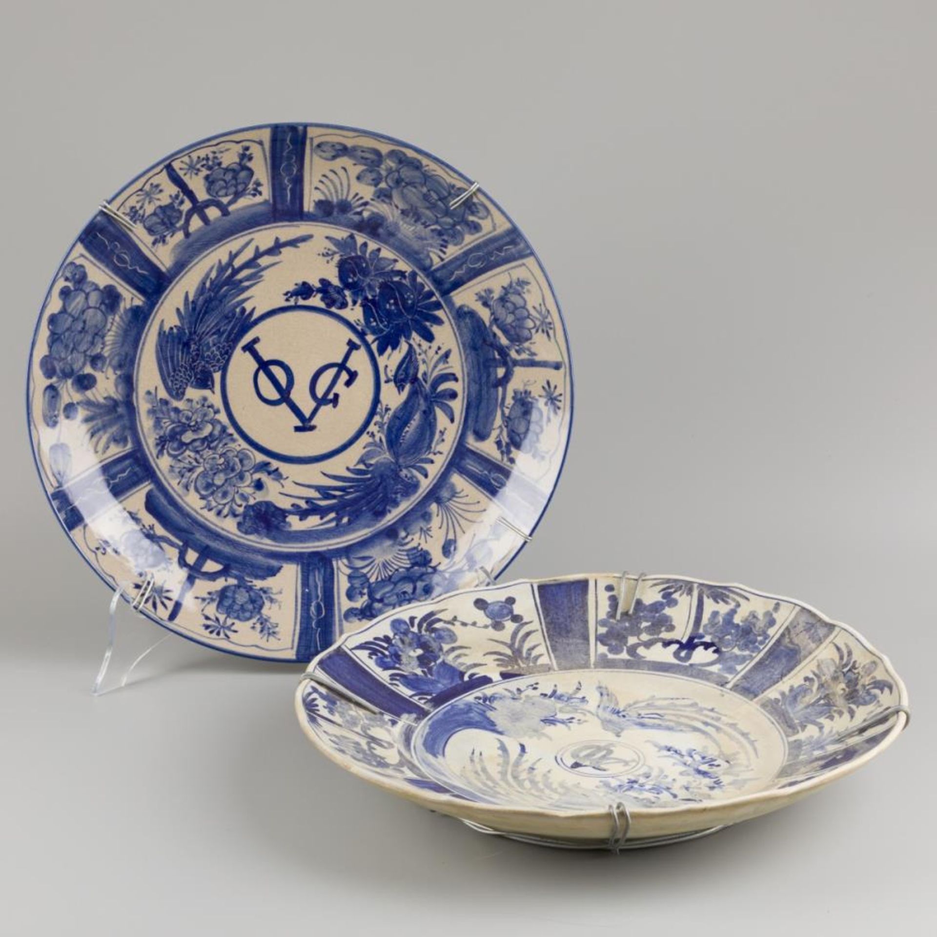 A lot comprising (2) various VOC wall chargers in blue and white motif, Dutch, 20th century.