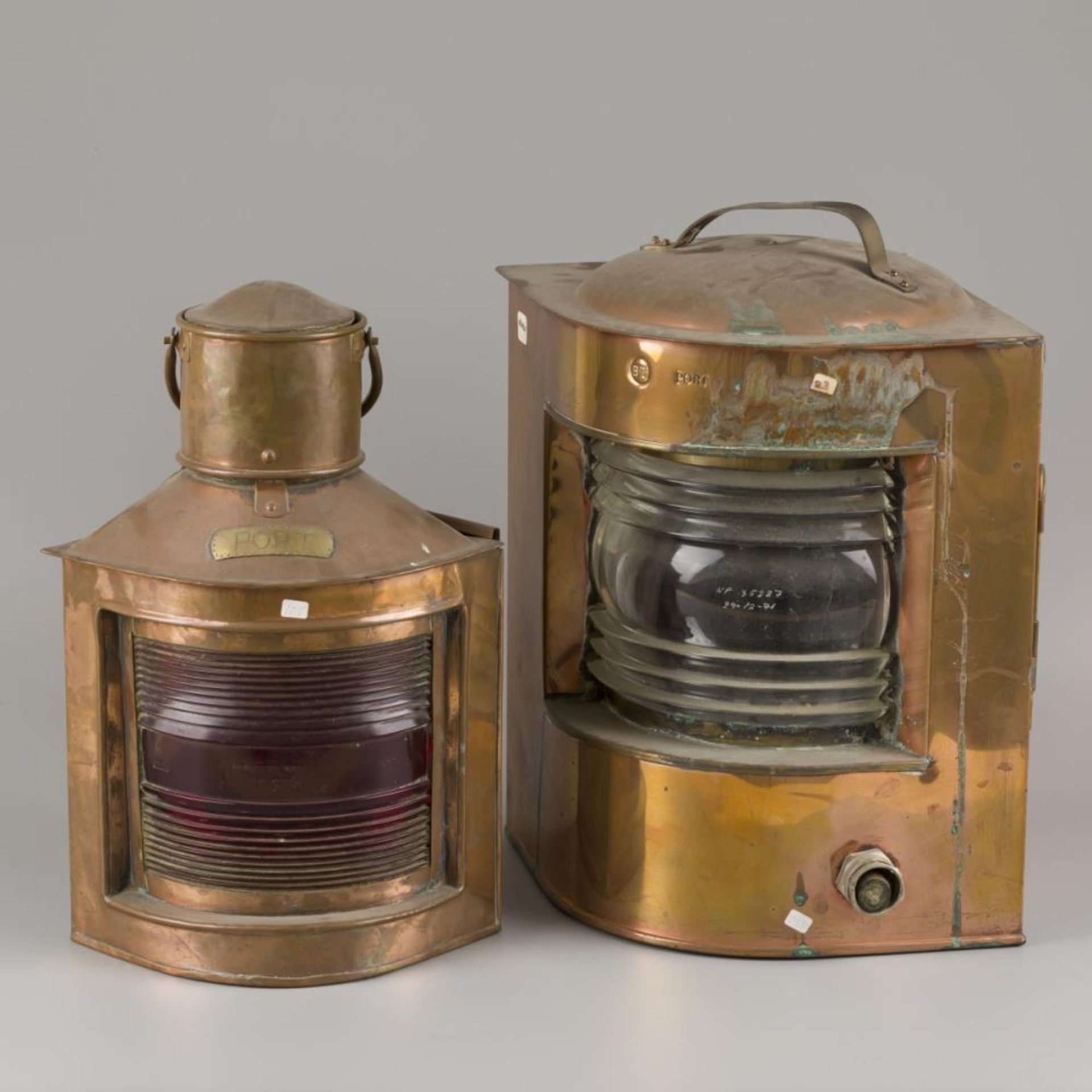 A lot comprising two storm lamps / -lights, a.w. with red glass, 20th century.