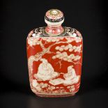 An ivory snuff bottle decorated with various figures under a blossom tree. China, late 19th century.
