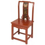 A red laquered Chinese chair.