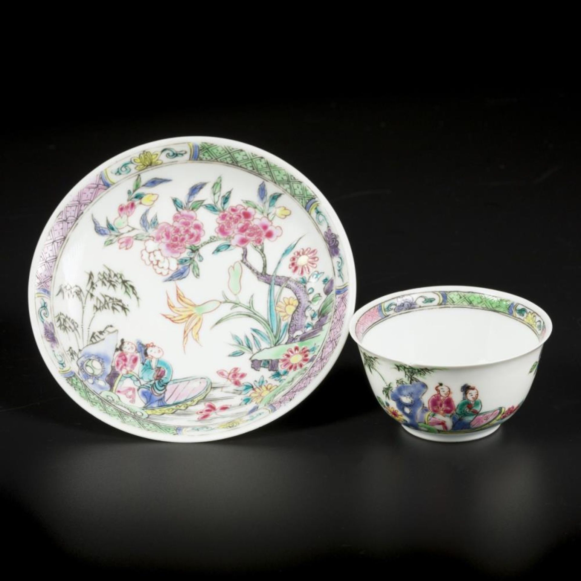 A Famille Rose cup and saucer with river landscape with figures decor China Yongzheng ca 1735.