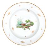 A porcelain plate with polychrome decorations of a duck and a pigeon, late 18th century.