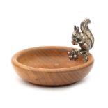 A wooden tray with a German silver squirrel.