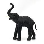 A black leather lined figure of an elephant with white plastic tusks. 75 x 65 x 23 cm. (hxwxd)