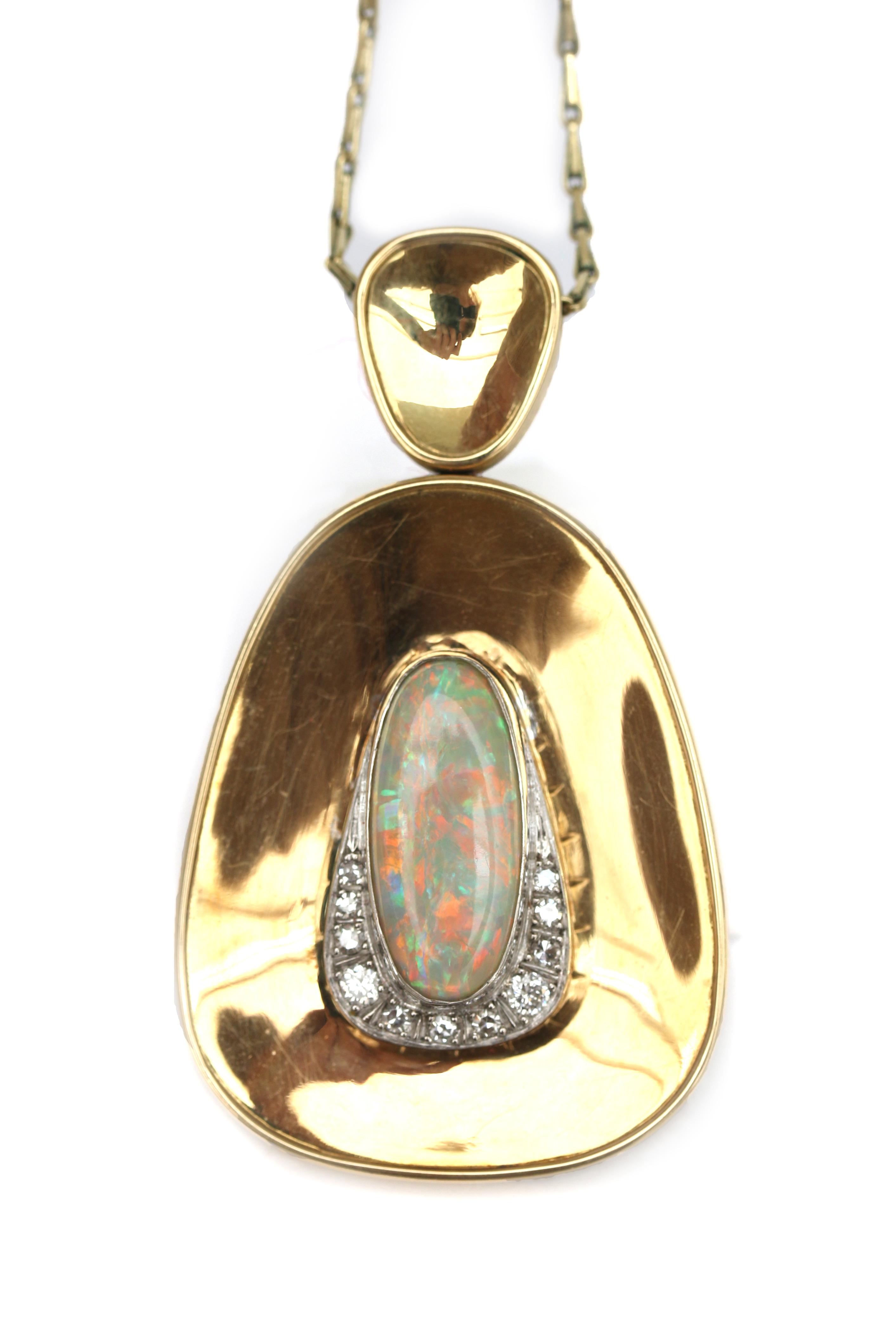 A 14 gold necklace with an opal and diamond pendant