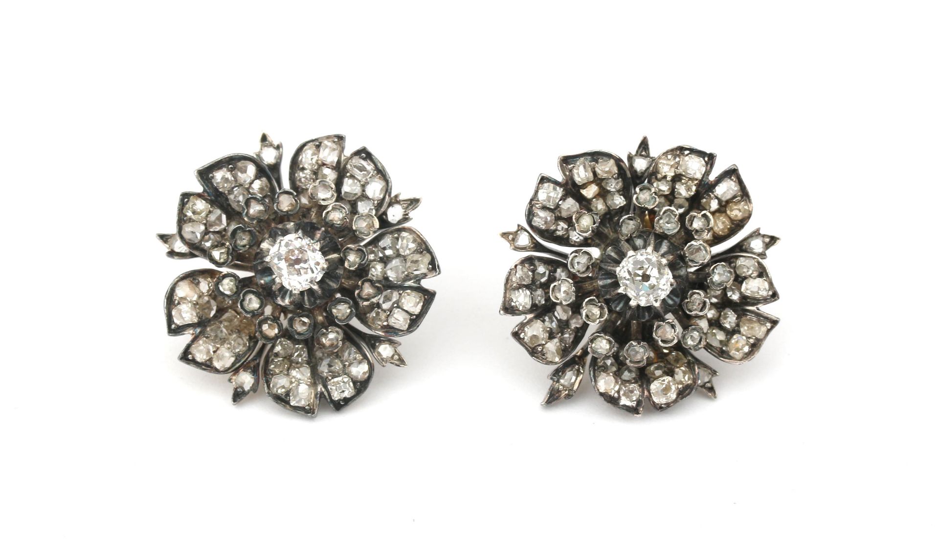 A pair of 14 karat gold and silver diamond earrings