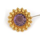 A 14 karat gold amethyst brooch