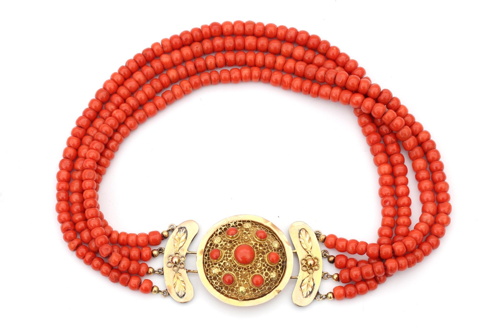 A precious coral four strand neckace to a 14 carat gold clasp