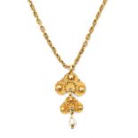 A 14 karat gold necklace with a gold filigree and pearl pendant.