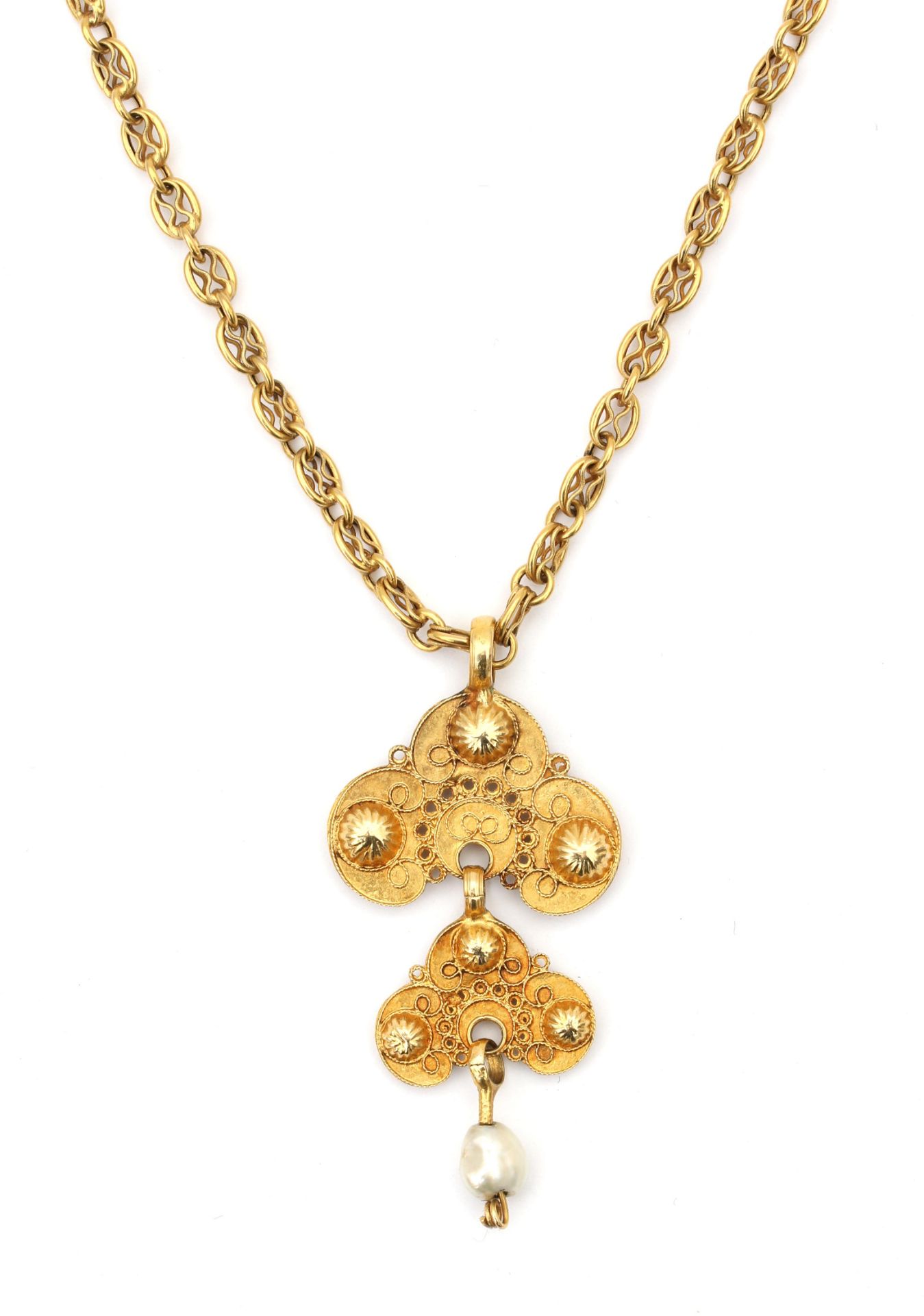 A 14 karat gold necklace with a gold filigree and pearl pendant.