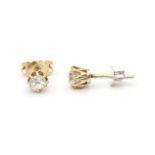 A pair of gold diamond solitair studs