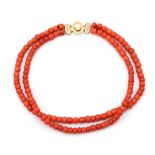 A precious coral two strand necklace on a 14 karat gold clasp