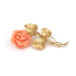 An 18 karat gold flower brooch with angelskin coral