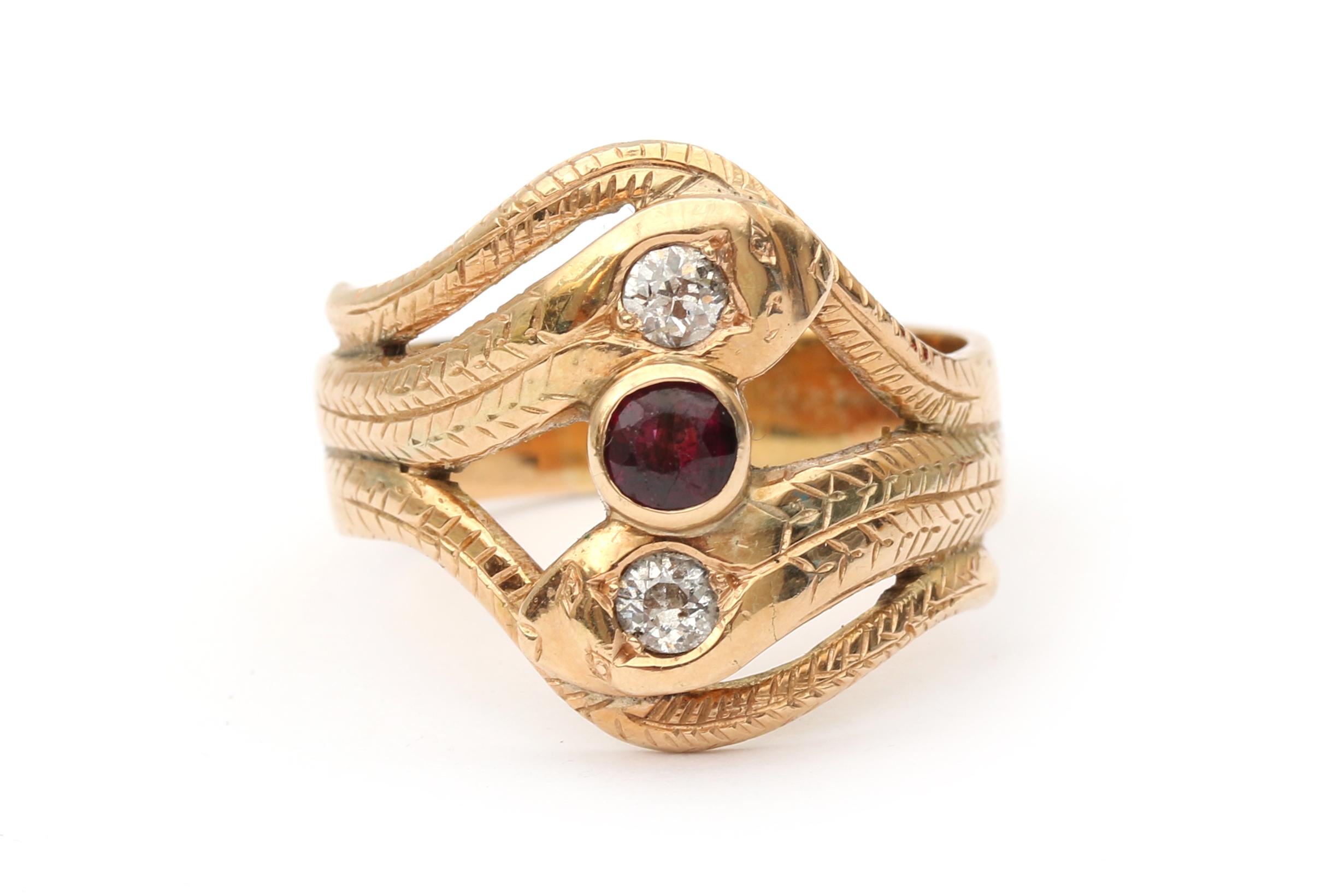 A 14 karat gold gold diamond and ruby snake ring