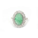 A 14 karat white gold jade and diamond cluster ring