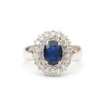 An 18 carat white gold diamond and sapphire cluster ring