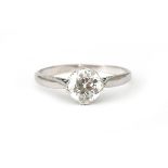 A platinum solitaire ring with an old brilliant cut diamond