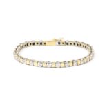 A 14 karat two tone gold diamond tennis bracelet