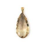 A 14 karat gold smokey quartz pendant