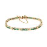 A 14 karat gold emerald and diamond bracelet