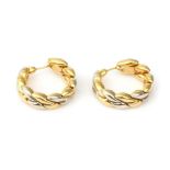A pair of 18 karat two tone gold ear hoops