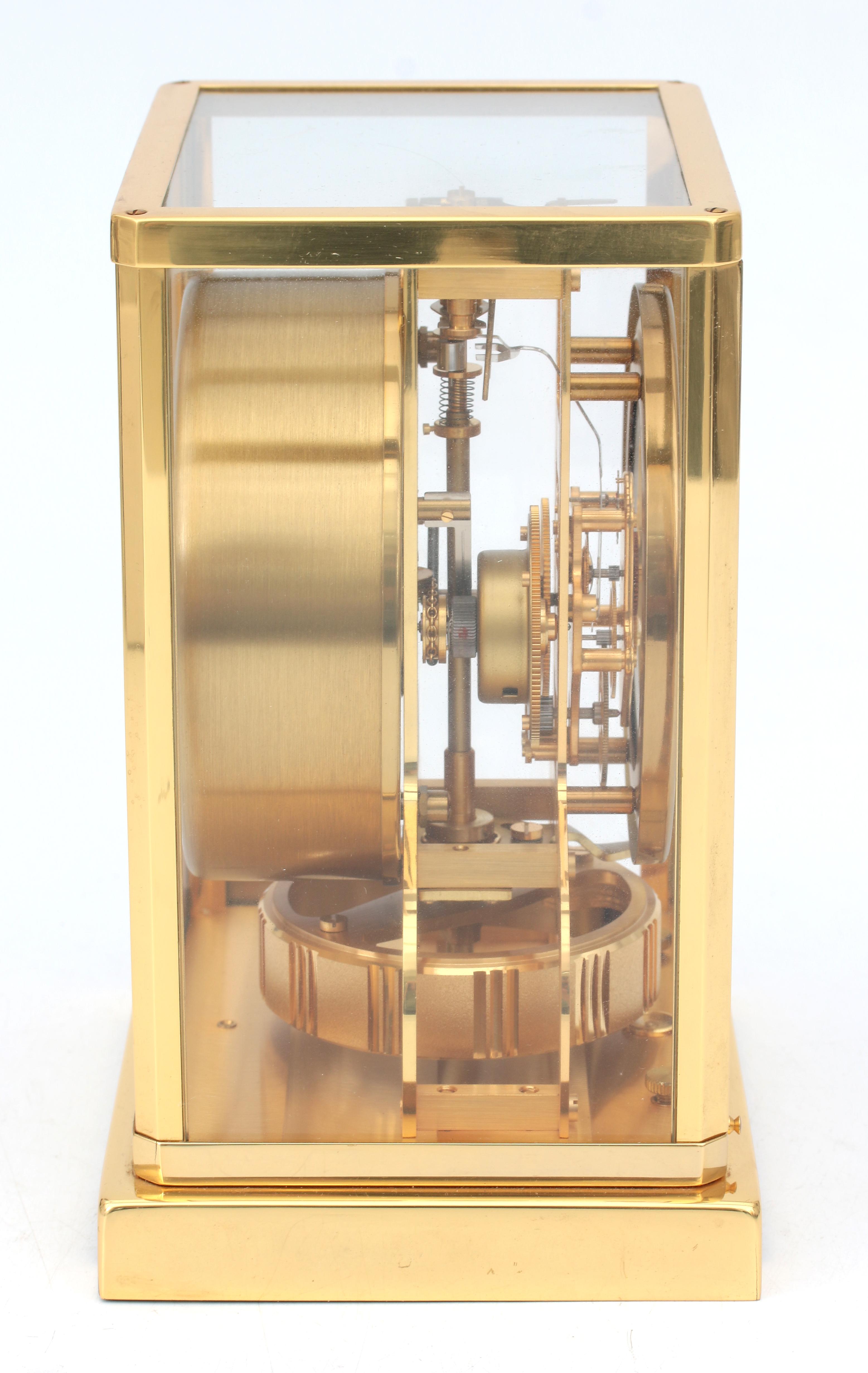 A perpetuum moving clock in gold-plated metal and glass case, Jaeger leCoultre, Swizerland, circa 19 - Image 4 of 5