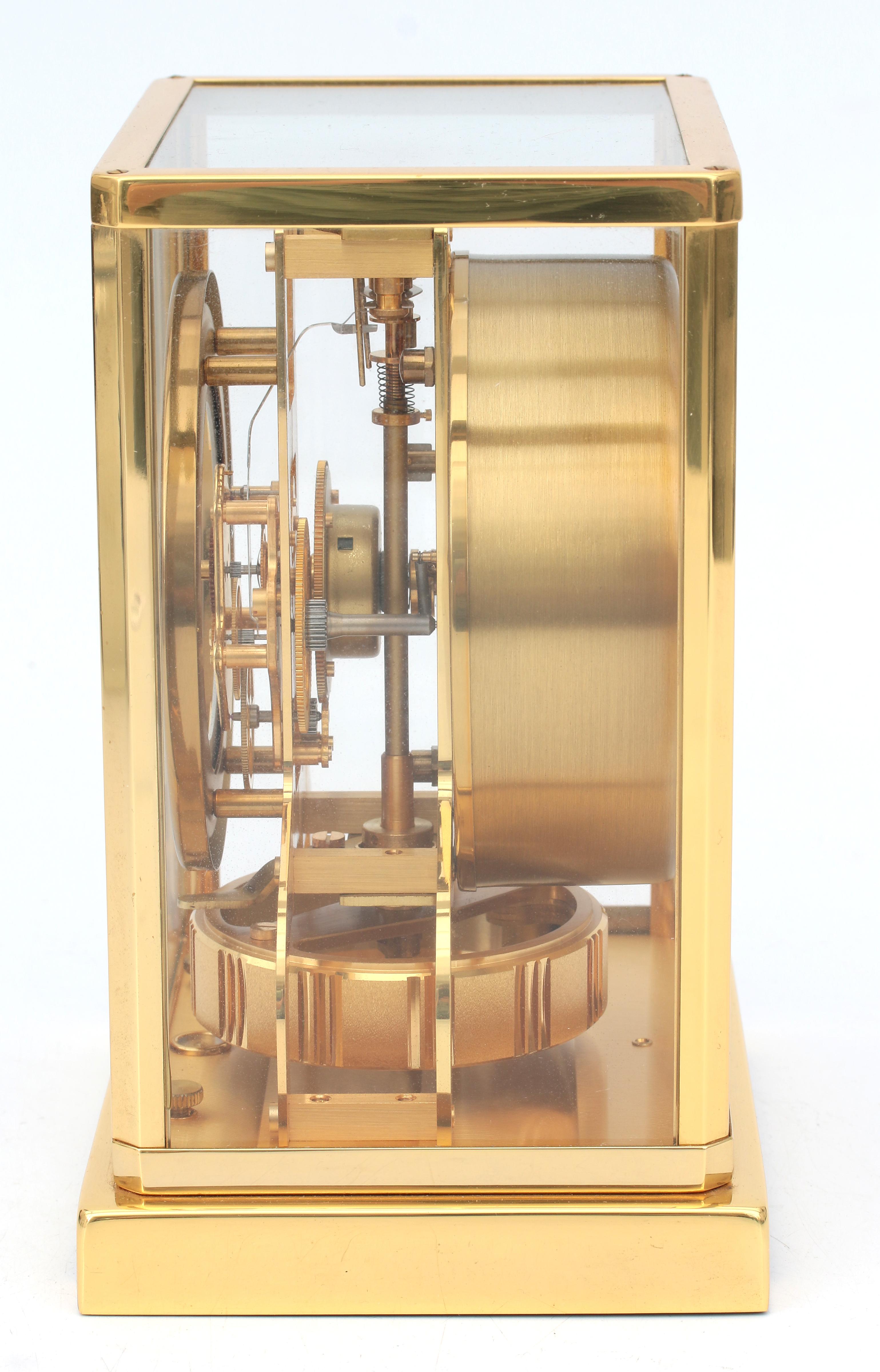 A perpetuum moving clock in gold-plated metal and glass case, Jaeger leCoultre, Swizerland, circa 19 - Image 3 of 5