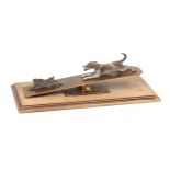 A letter clip on a wood base showing a dog chasing a hare, both Vienna bronzes, probably Bergman, ci