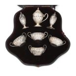 A 925 silver set of four salt cellars, two casters and a mustard pot in original cassette, Henry Cha