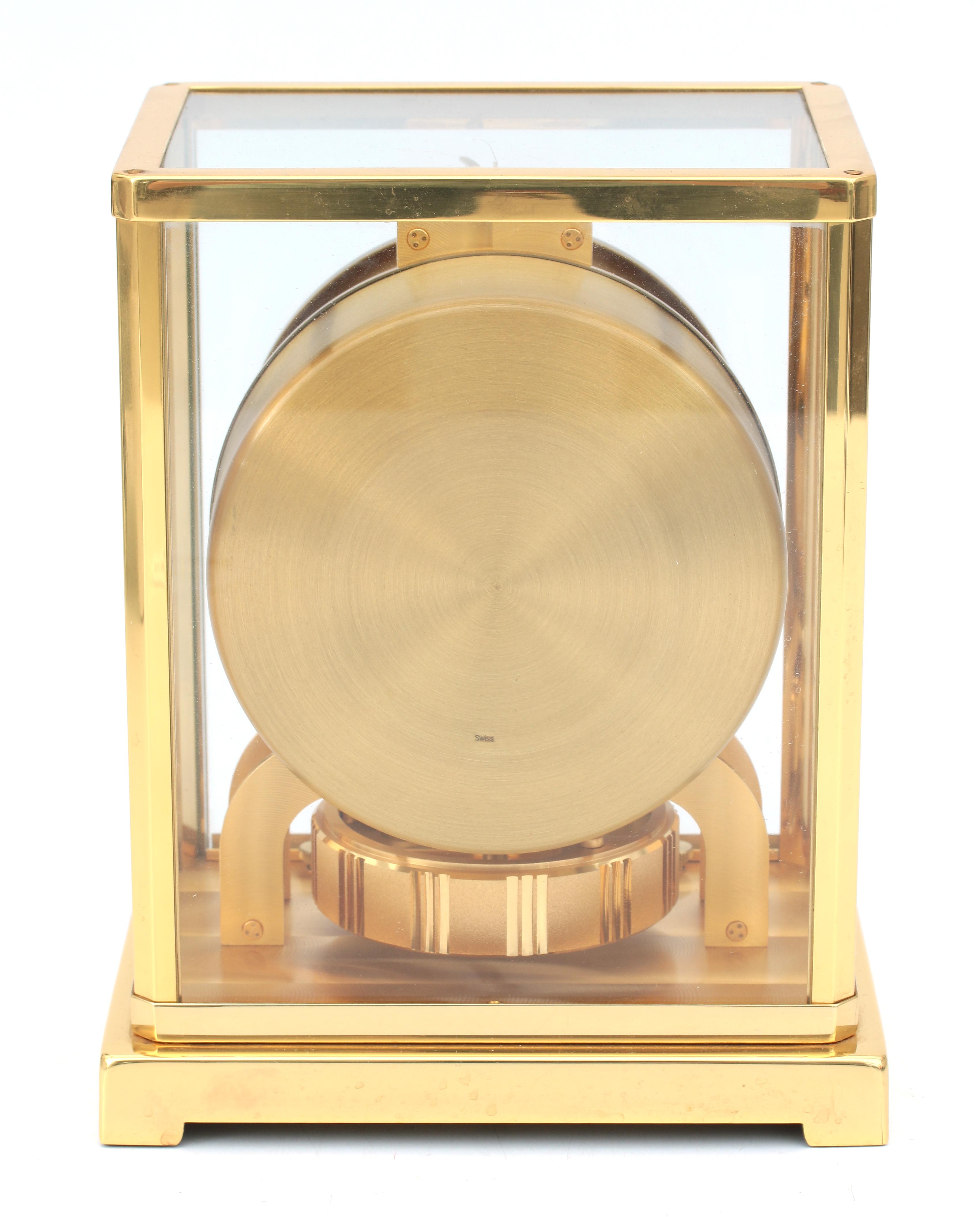 A perpetuum moving clock in gold-plated metal and glass case, Jaeger leCoultre, Swizerland, circa 19 - Image 5 of 5