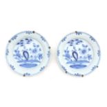 A pair of blue and white Delft earthenwarewall plates with Chinese garden decoration, 18th century.