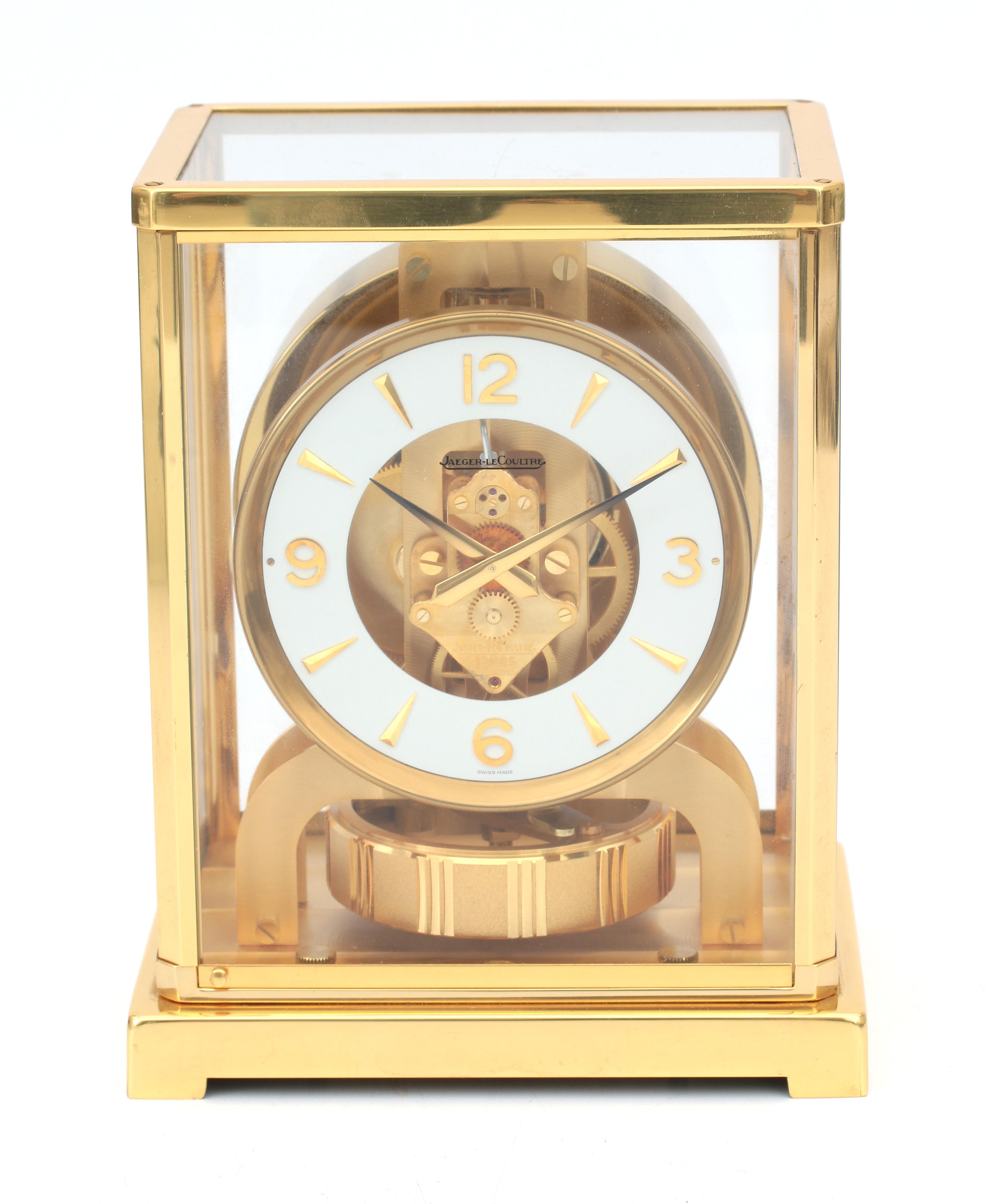 A perpetuum moving clock in gold-plated metal and glass case, Jaeger leCoultre, Swizerland, circa 19