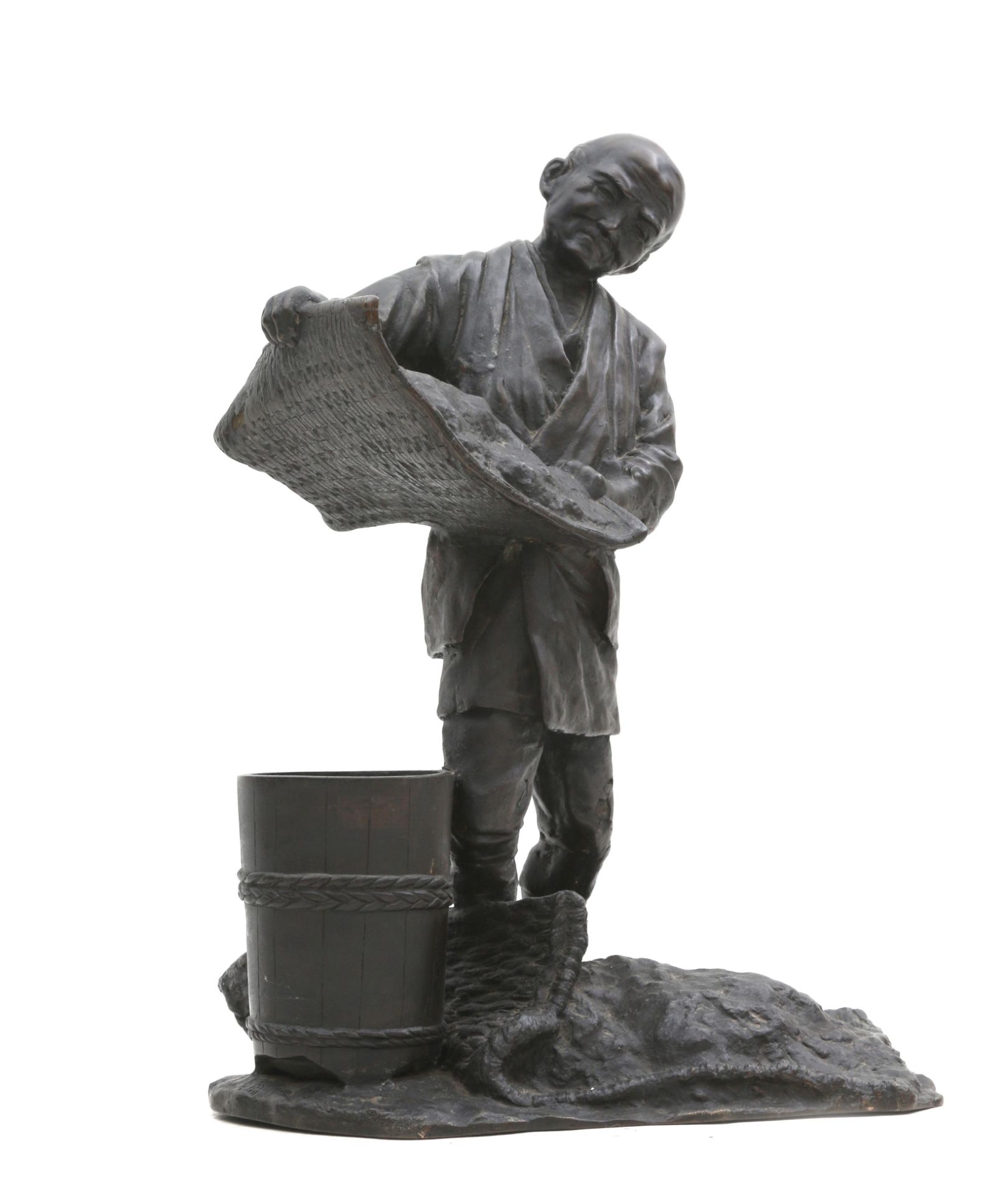 A Japanese bronze sculpture of a man with bucket and sieve, signed, Meiji-period. 