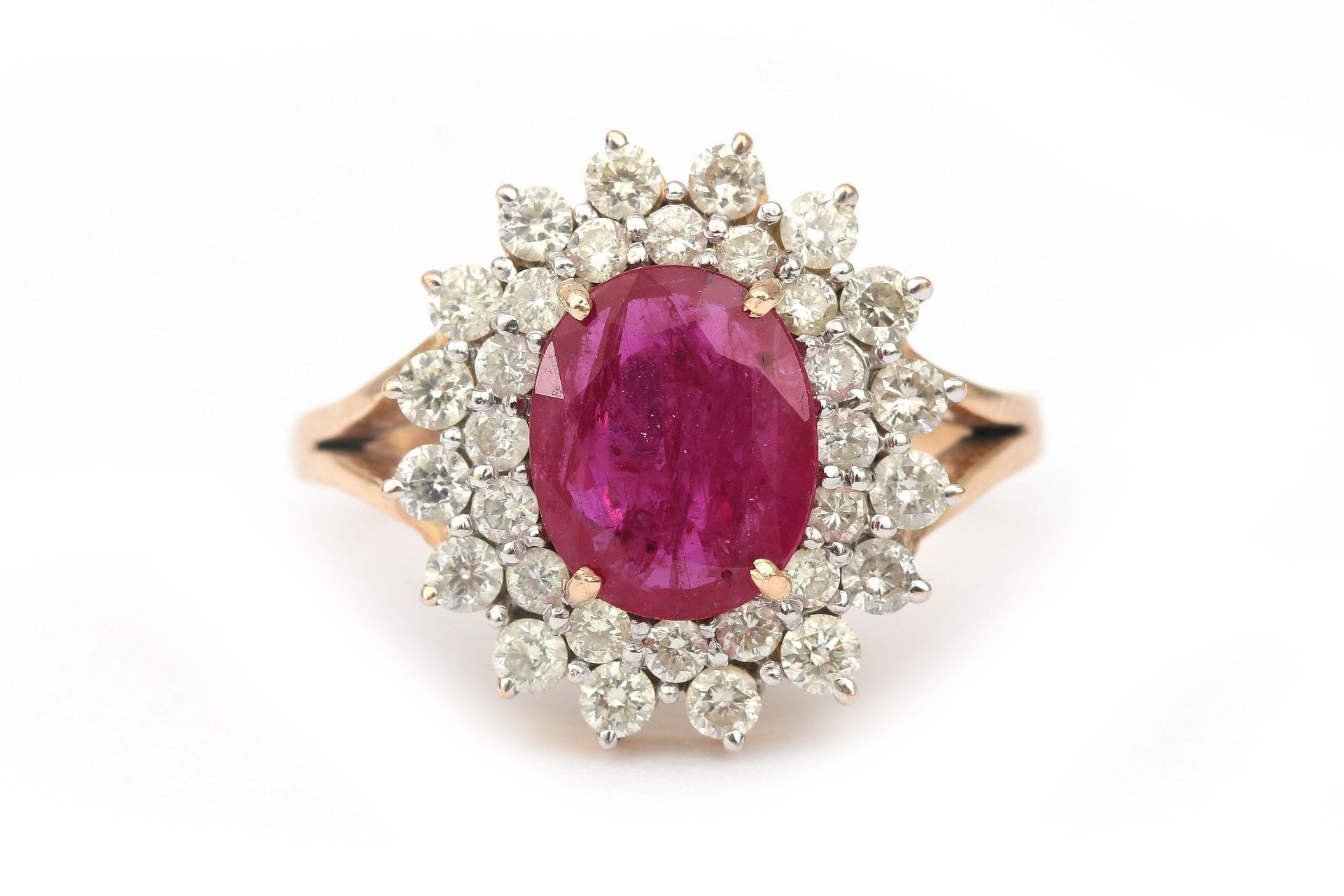 A 14 karat gold ruby and diamond cluster ring