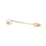 A gold pearl and diamond tie pin