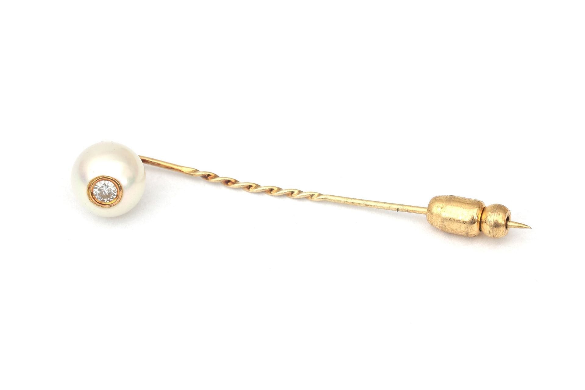 A gold pearl and diamond tie pin 