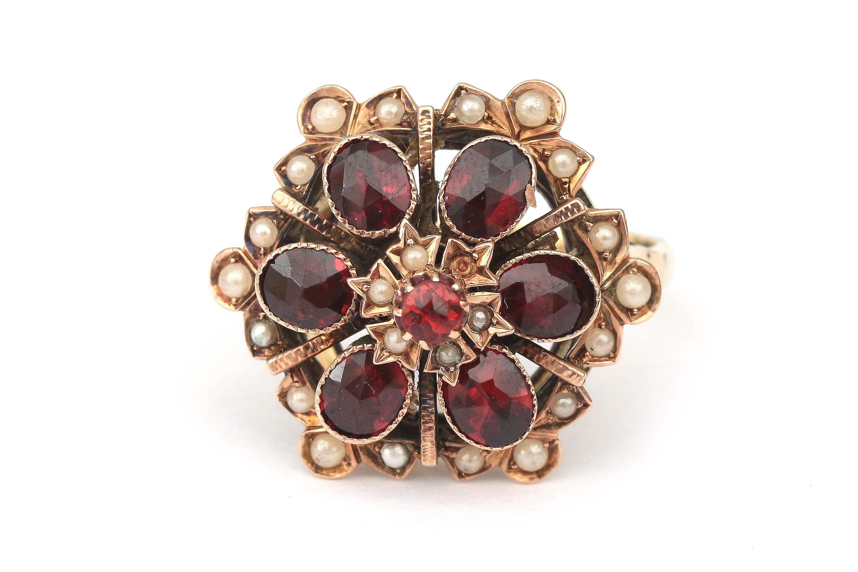 A gold garnet and pearl cluster flower ring