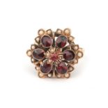 A gold garnet and pearl cluster flower ring